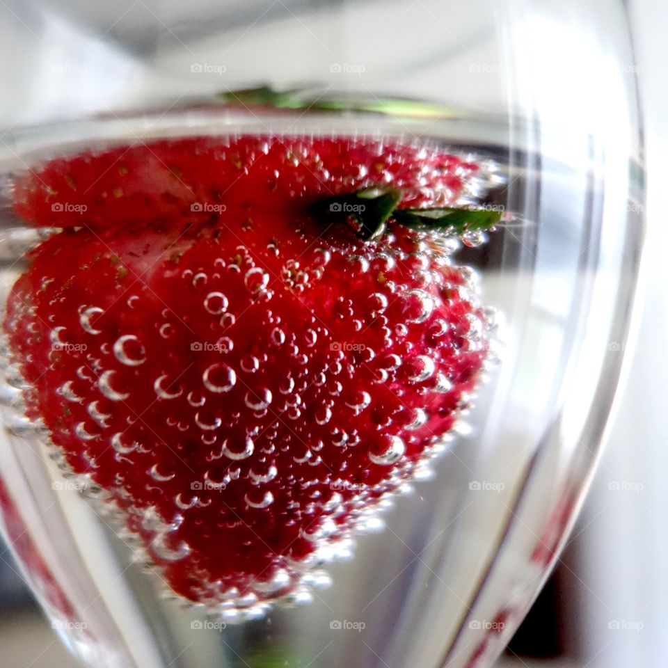 Strawberry in drinking glass