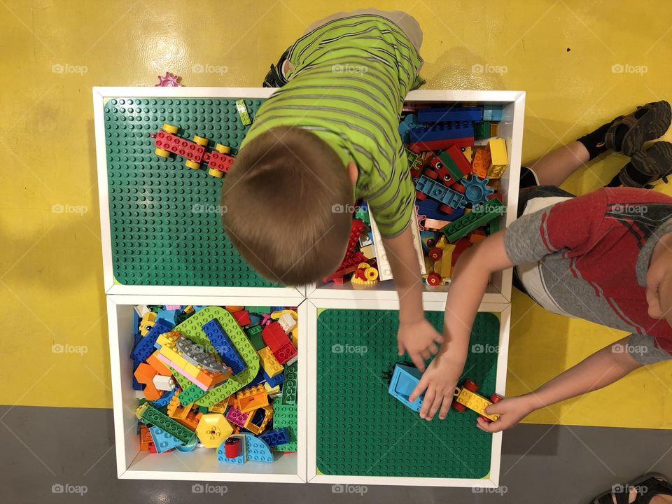 Boys playing with Lego blocks 