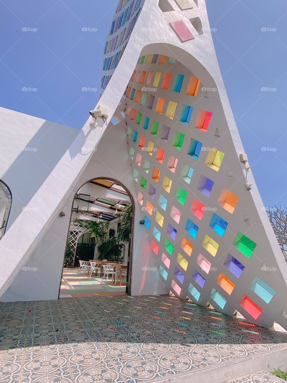 Shimmering Facades: White Architecture Adorned with Multicolored Glass 