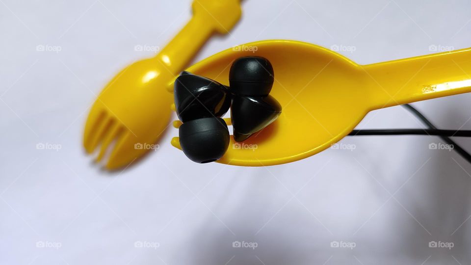 Yellow forks Trying to grab some music with earphones