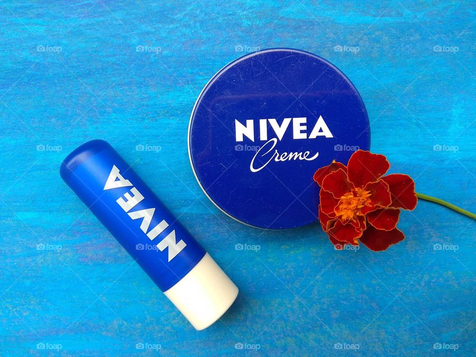 Nivea cream and lipstick summer time blue background, love products