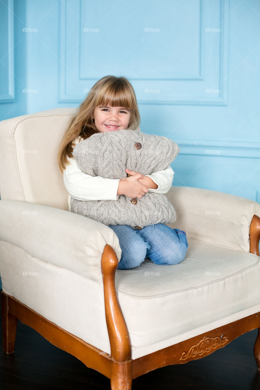 Happy girl sitting on chair