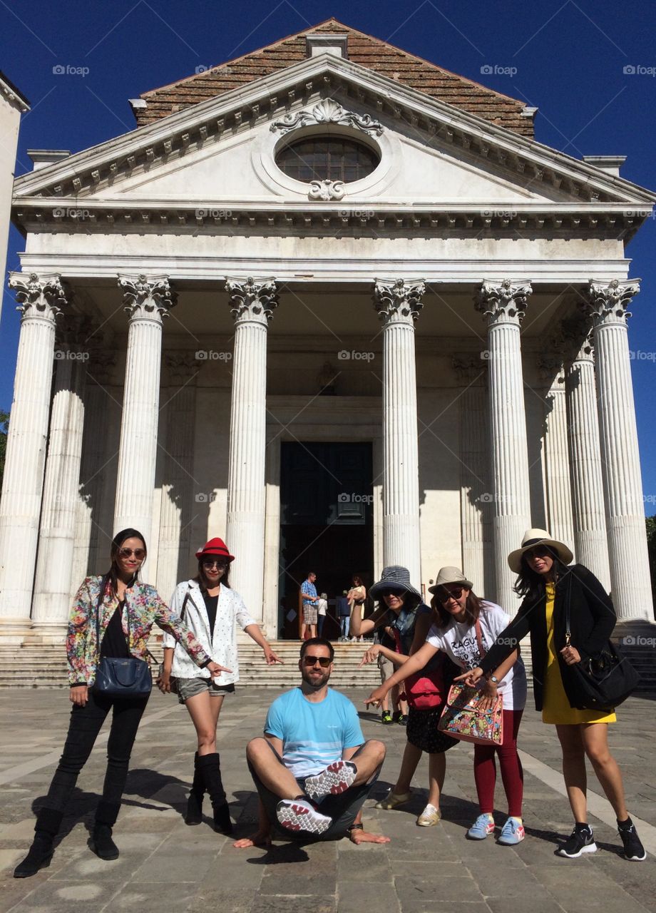 Group of tourist posing in front of town hall