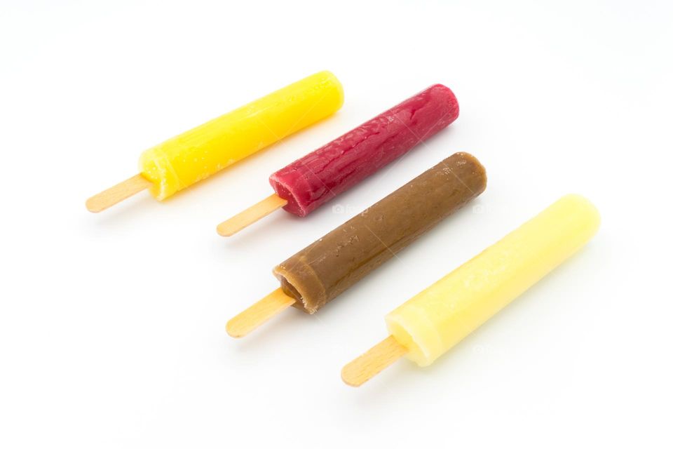 Assortment of ice lollies (popsicles) of different flavours. Isolated on a white background.