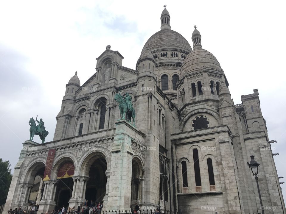 Up close look at The Basilica of the Sacred Heart of Paris, or Sacré-Cœur, on a rainy day in Paris, France. 