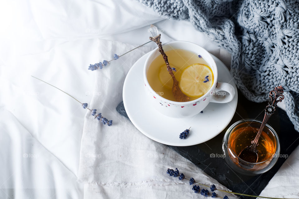 Tea with honey on bed