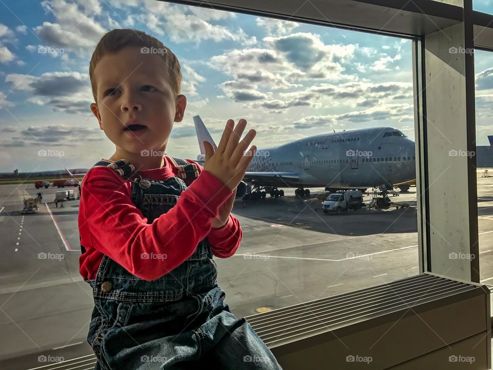 Boy looking at the window in the airport 