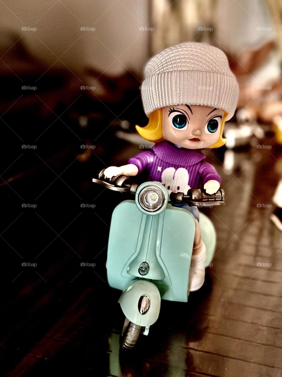 Cute toy doll on a scooter