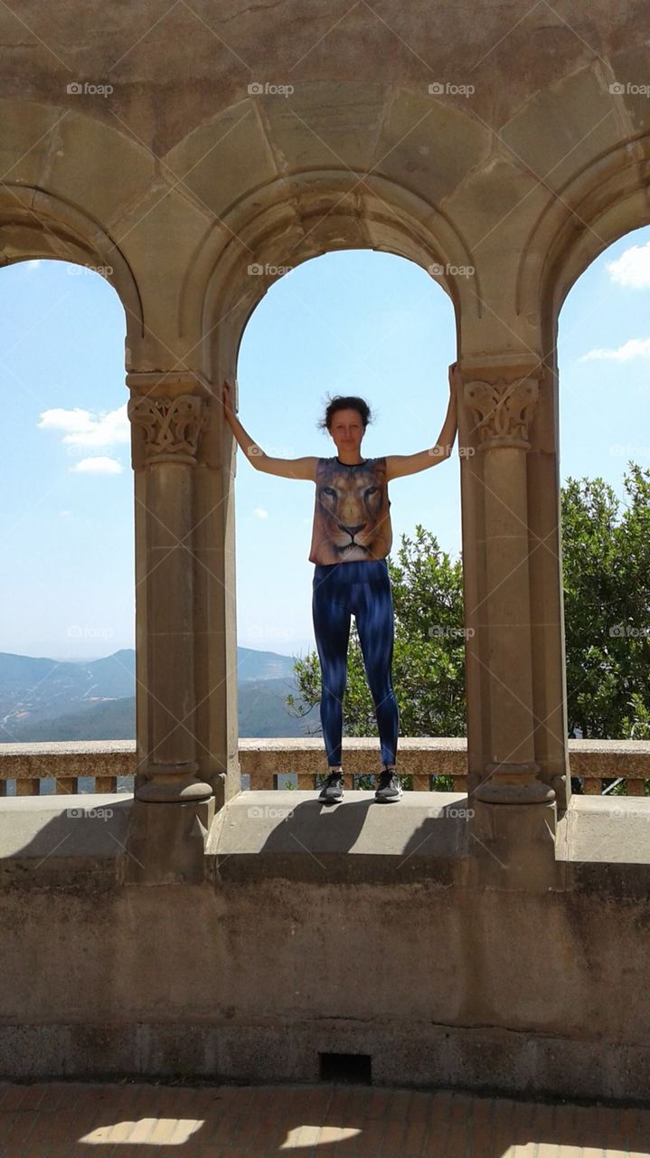 Young woman stands between arches of an ancient structure against the backdrop of beautiful countryside.

Montserrat Abbey in Catalonia.

(not the clearest photo, but I love it🙂)