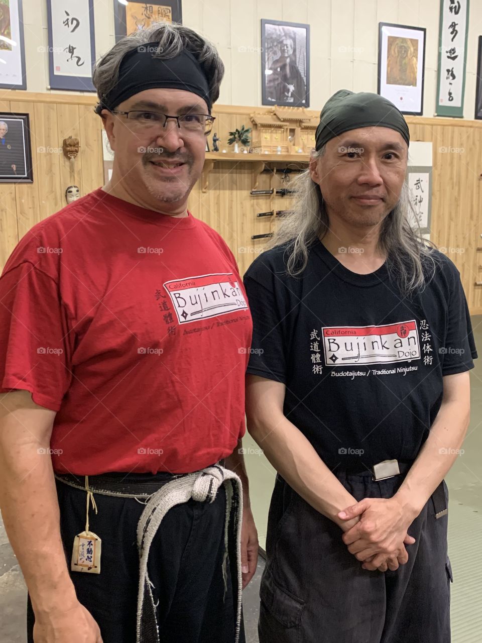 Sensei (left) and one of his martial arts students (right) at the dojo. They briefly are hanging out together after training. There is good camaraderie here.