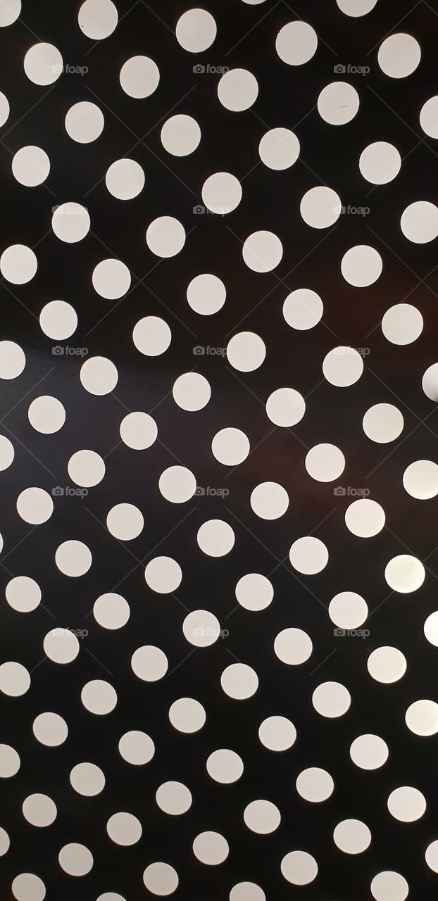 Polka dot light panel in an elevator. Could make a cool desktop wallpaper.