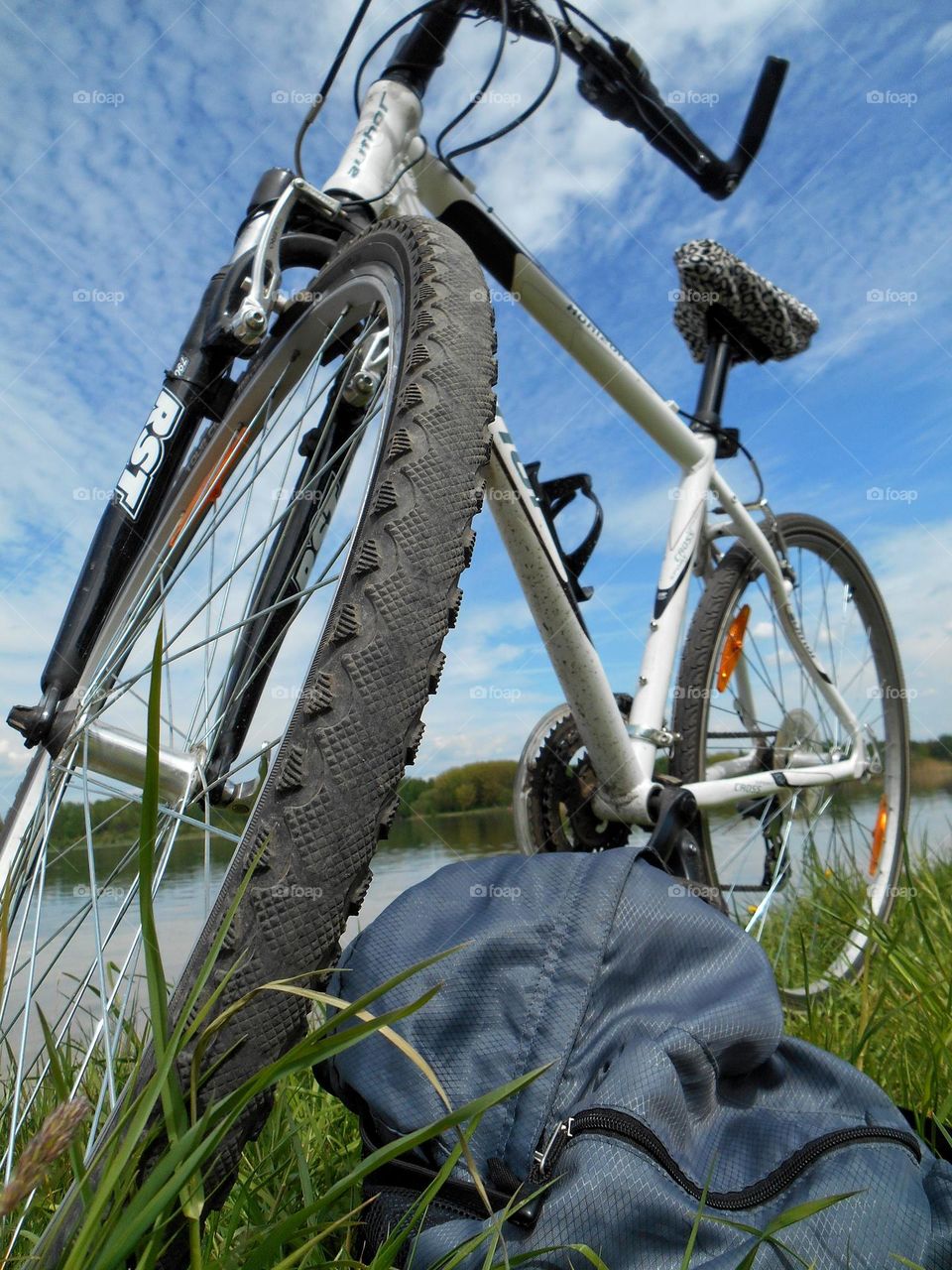 bike in grass outside blue sky background