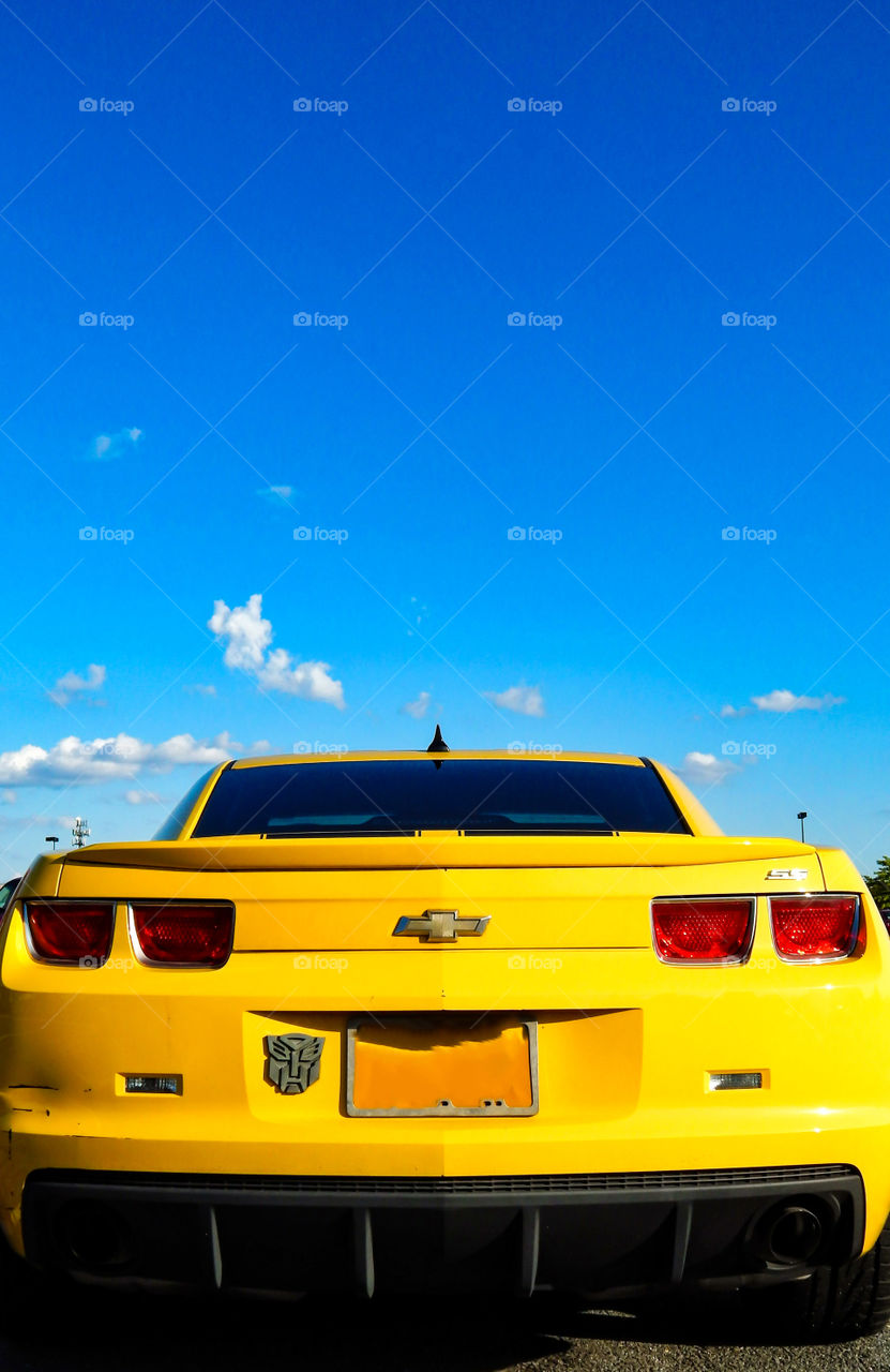 Yellow Mustang Under The Blue Sky