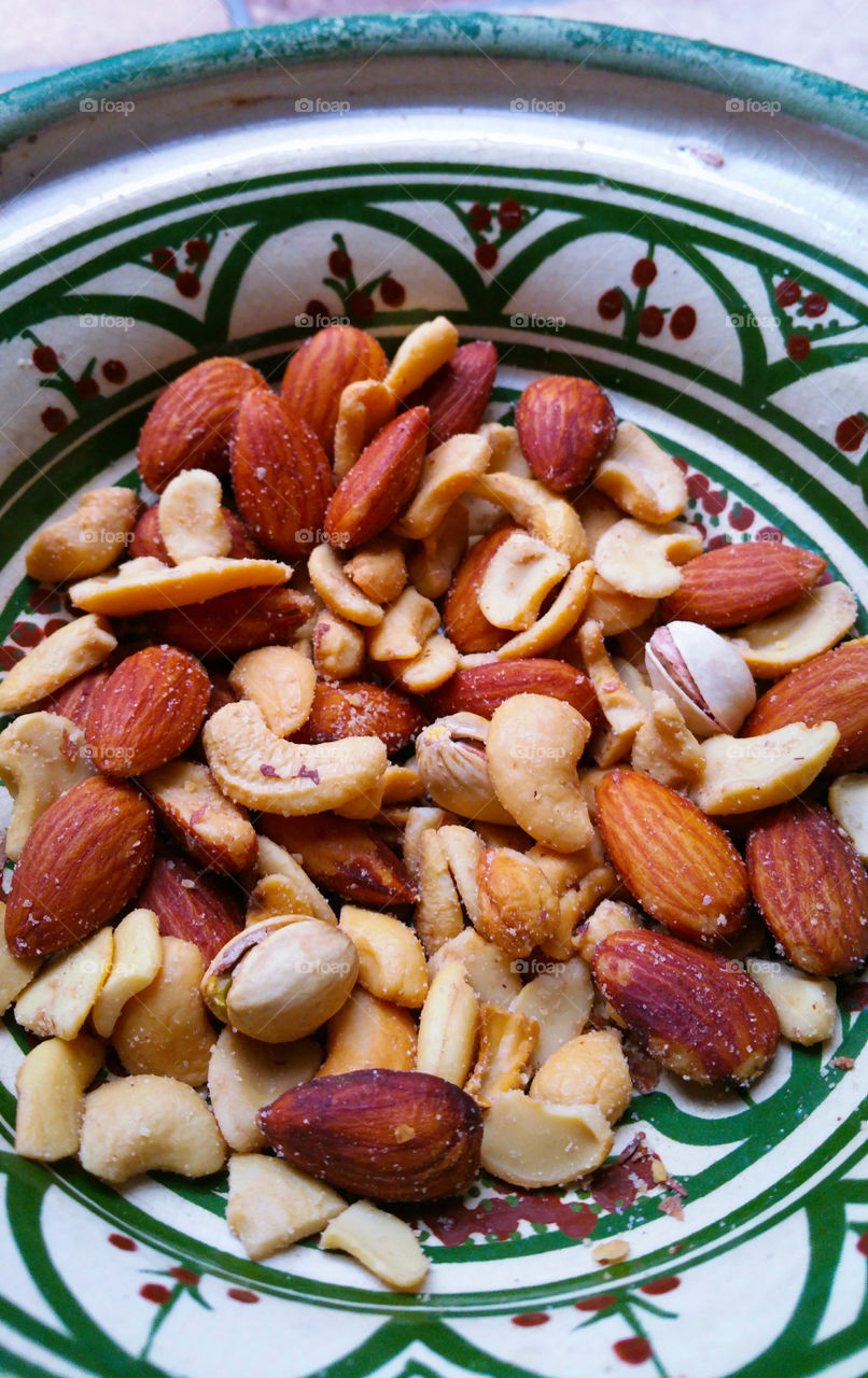 A handpainted bowl of salted roasted nuts