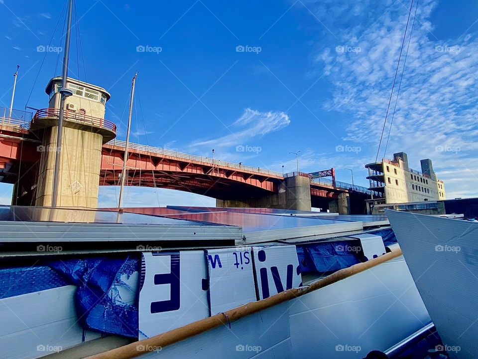 This is the „Pulaski Bridge“ at „Newtown Creek“ in LIC, Queens seen looking over the back of „Salvation“, the „28 ft 1969 Luhrs“ cabin cruiser that I live on together with my longtime partner. 2023. Hypnotic Productions
