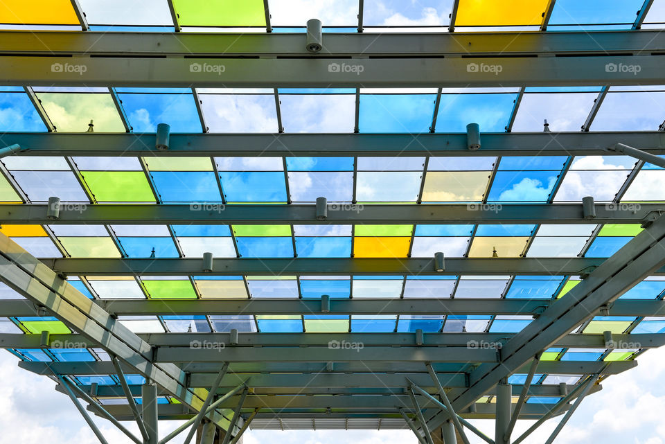 Different colored panels of glass against the sky