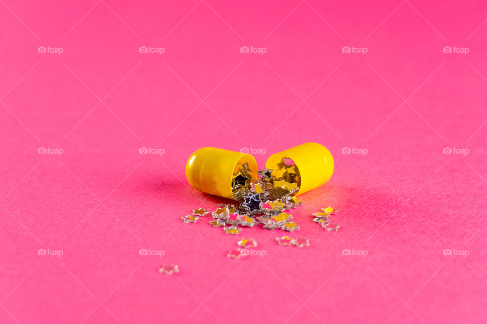 Creative pill open with little stars coming from it