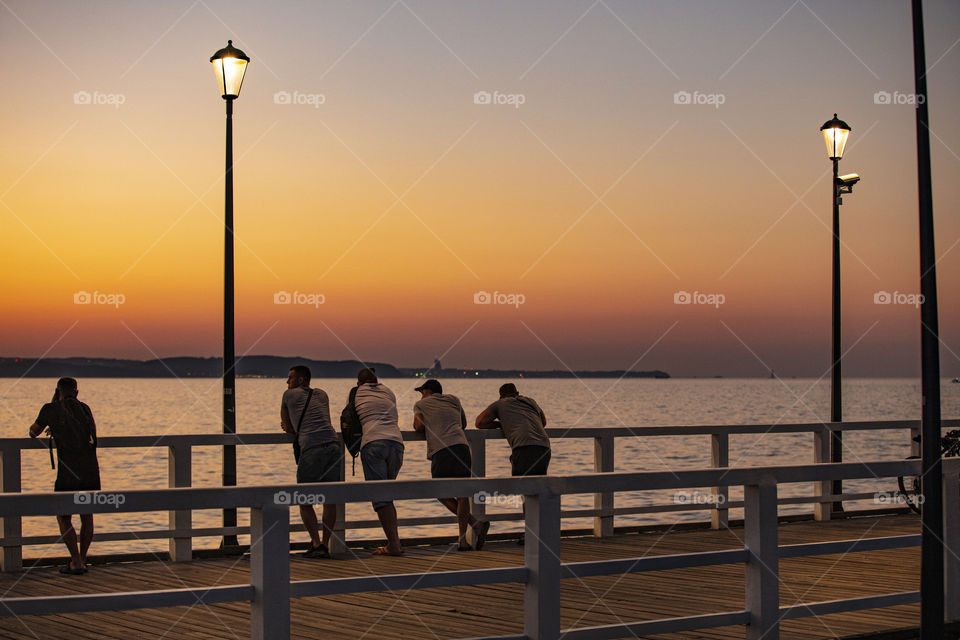 People watching sunset on the pier in Gdansk