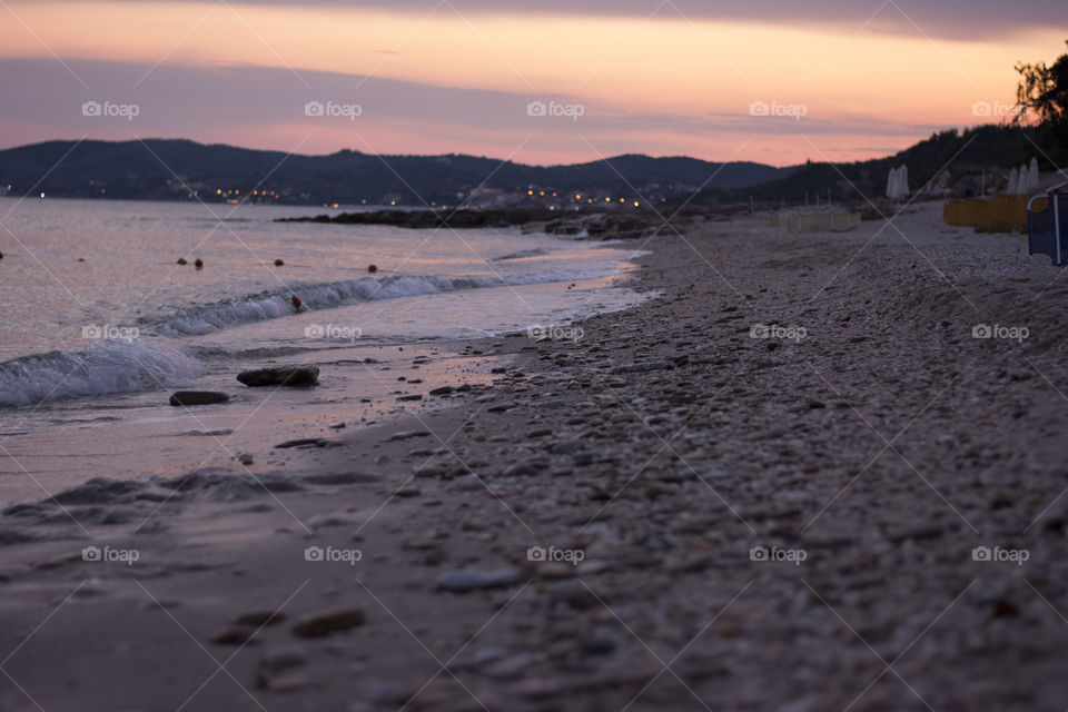 beach in the golden hour. beach with rocks in golden hour