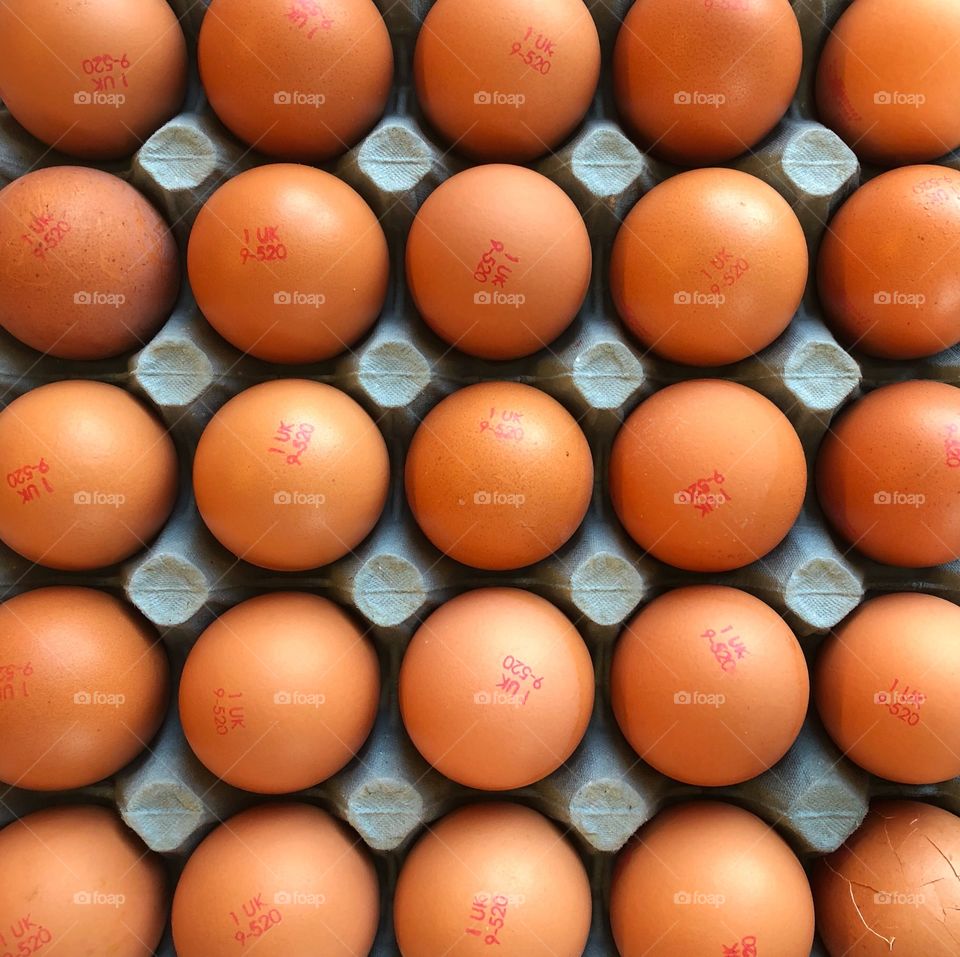 Rows of British eggs in cardboard tray 