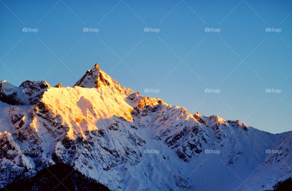 enthralling golden hues of sunset on Himalayan mountain peak