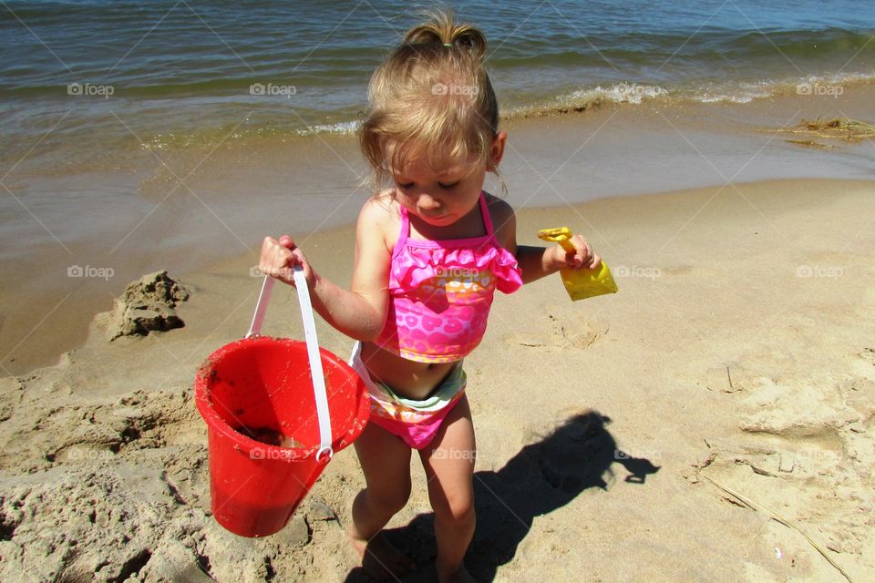 My first sand castle . Mila working hard at her first sand castle!