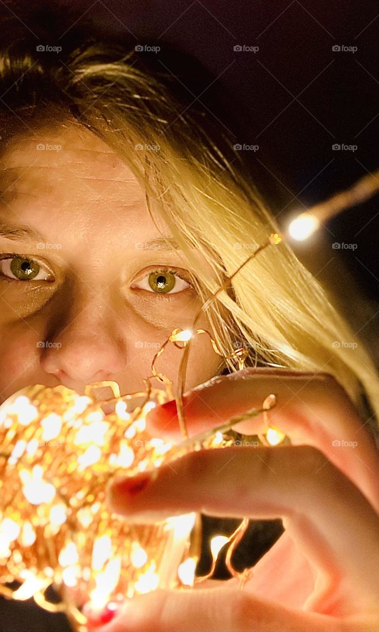 Eyes behind the Christmas lights