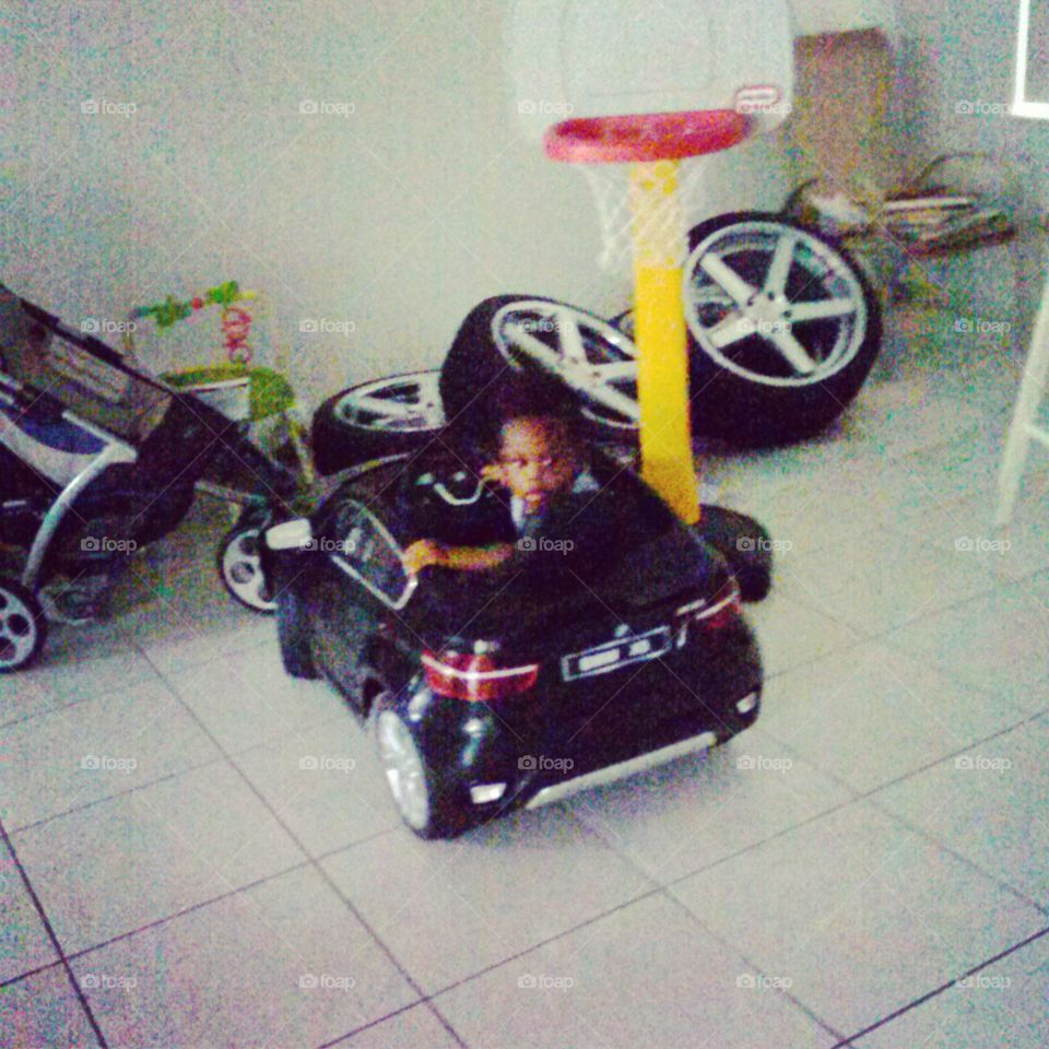 driving the car. My little cousin was playing with his car