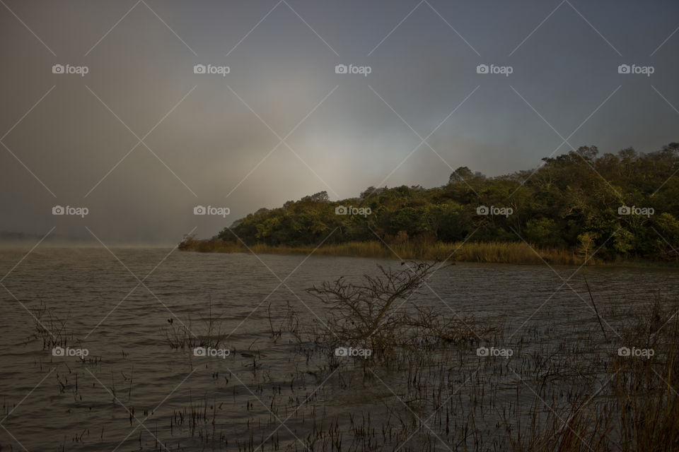 lake on sunrise with some mist in the air