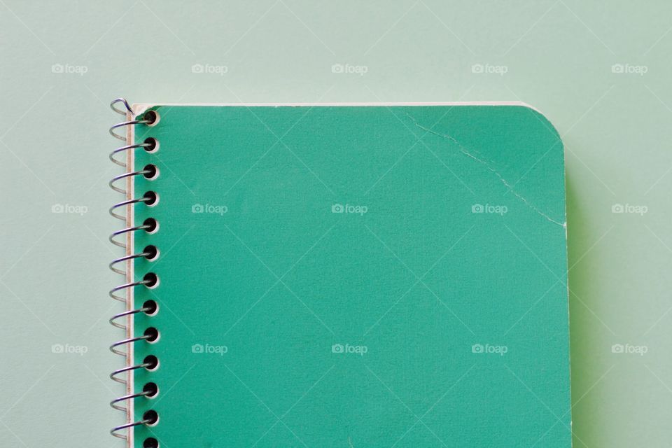 Elevated view of green spiral notebook