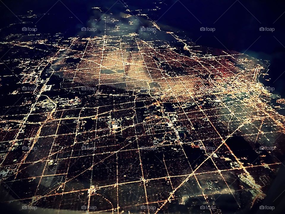 Ariel view  below of a repeating nighttime landscape grid.