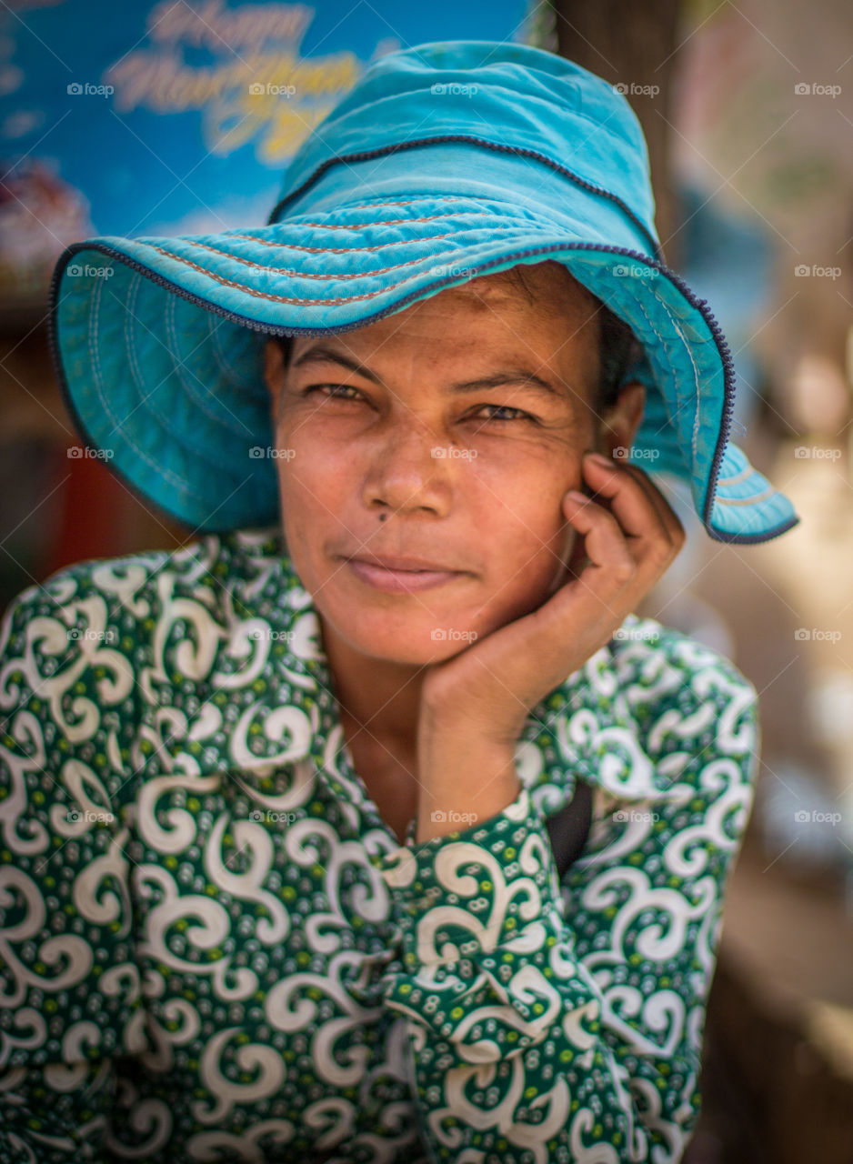 Market portrait with a blue hat