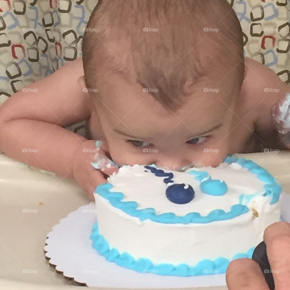 Diving right in to his first birthday cake. 