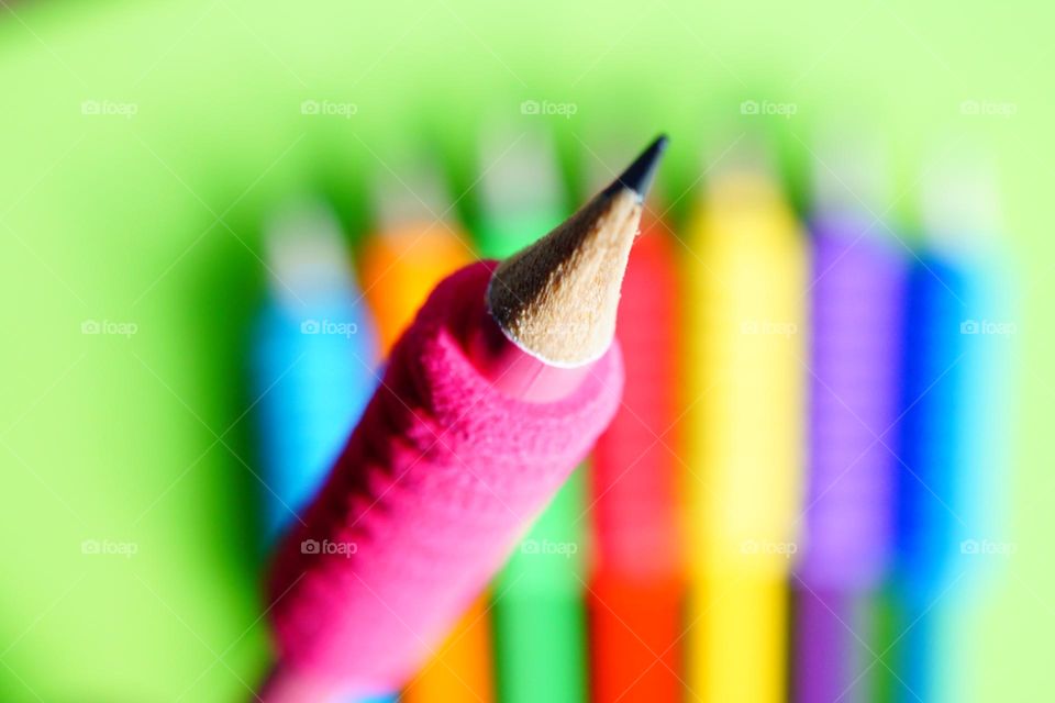 Bright pink gripper close up of a pencil point 