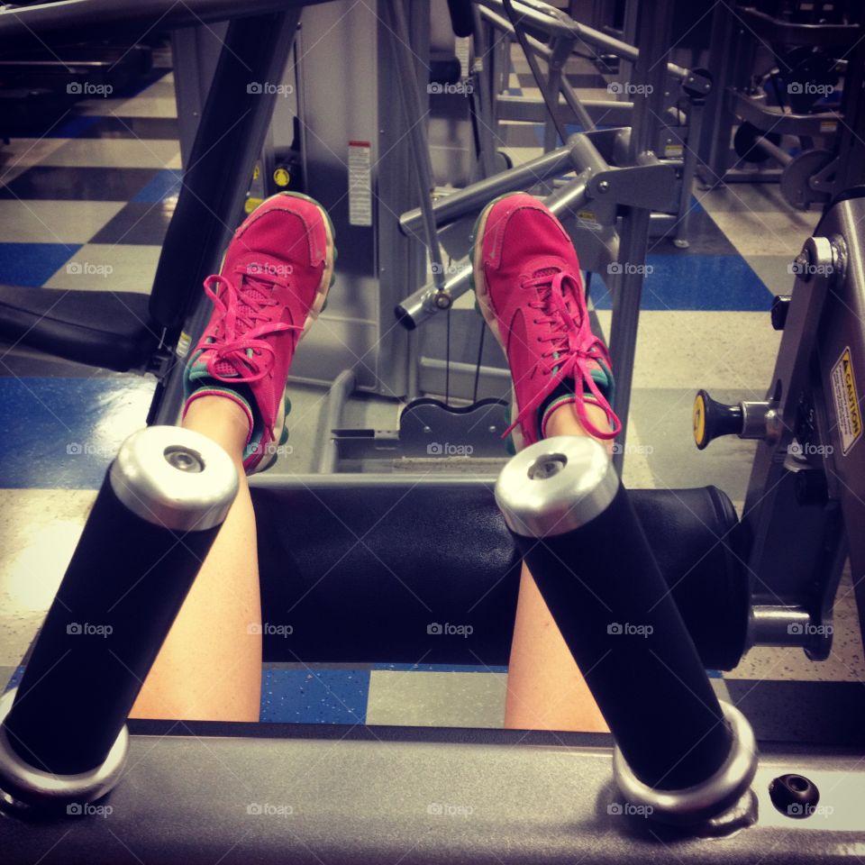 Resting on workout machines at the gym.