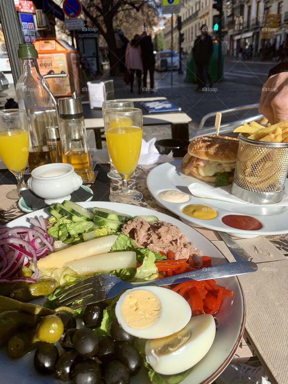 Fresh mixed salad, burgers and fries, lunch outside, summer meal 