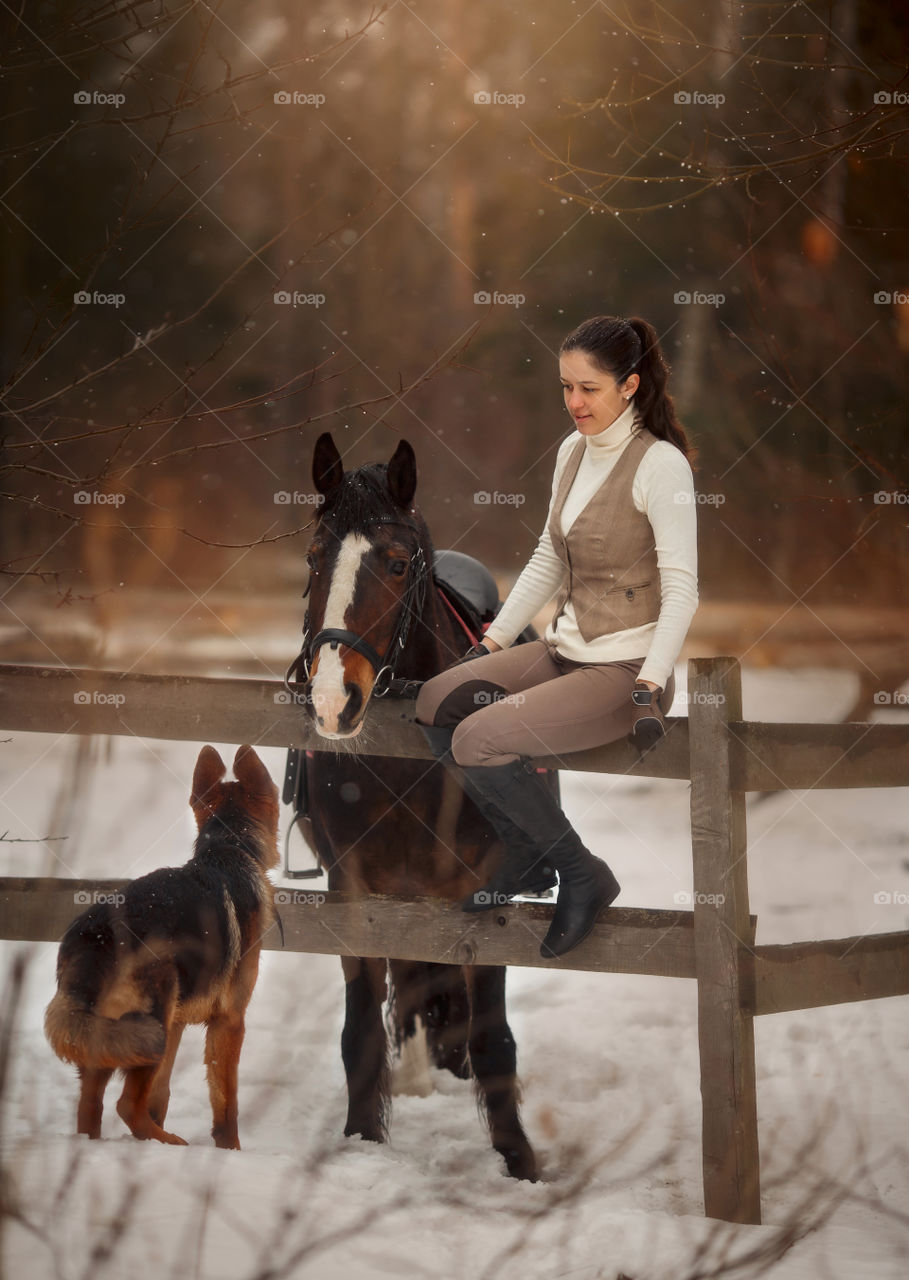 Young beautiful woman with horse and German shepherd dog outdoor portrait at spring day