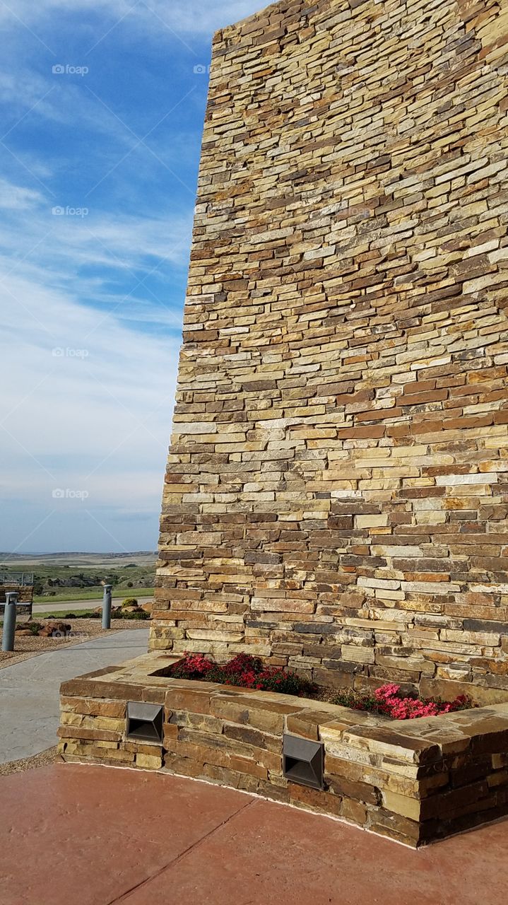 rock wall with Little Flower bed