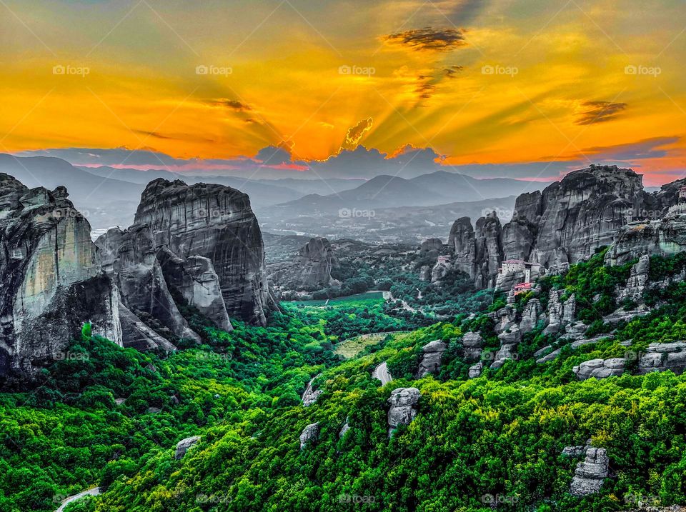 Sunset over Meteoras Monasteries and mountains 