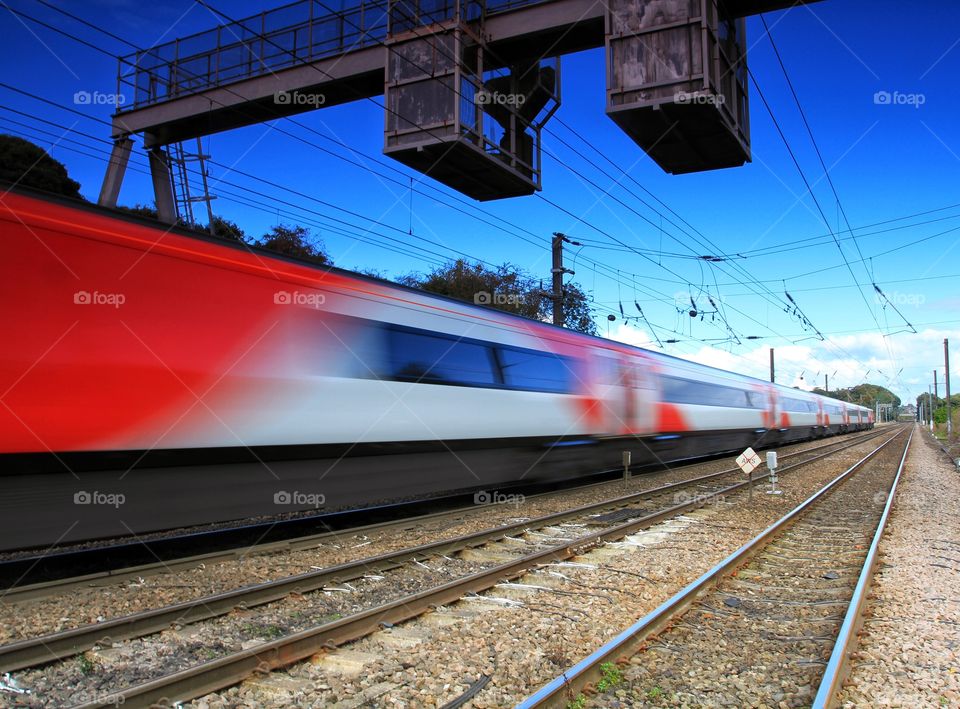 A speeding passenger express train with motion blur.