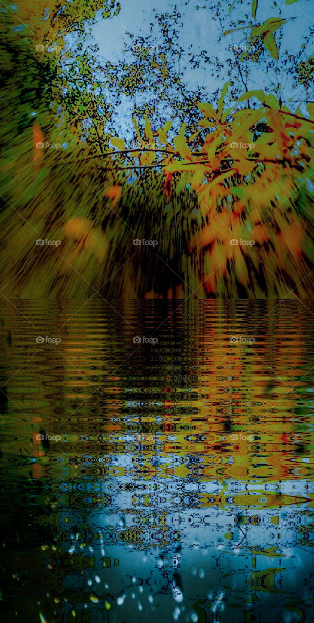 foap mission its autumn time colorful leaves of orange red yellow brown reflecting in the blue of the lake