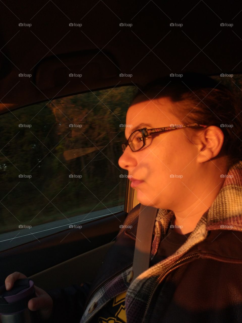 beautiful girl in the car during golden hour