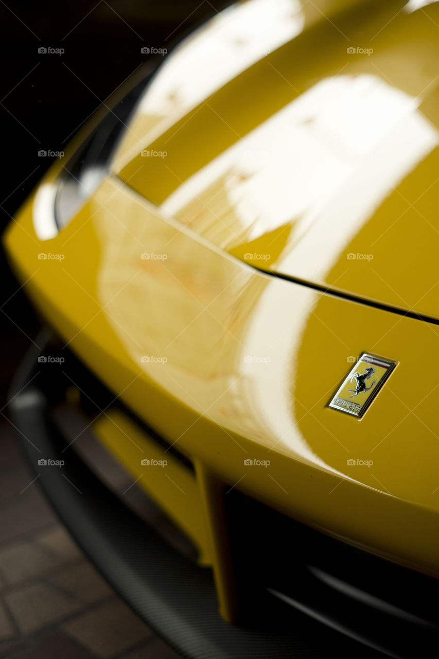 yellow Ferrari 488 spider coupe sports car 3.9 liter V8 twin turbo charged  (F154CB V8) close up front logo