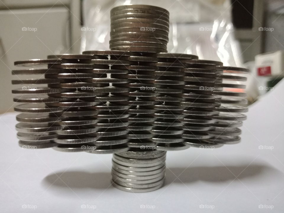 Balancing stacked coins art