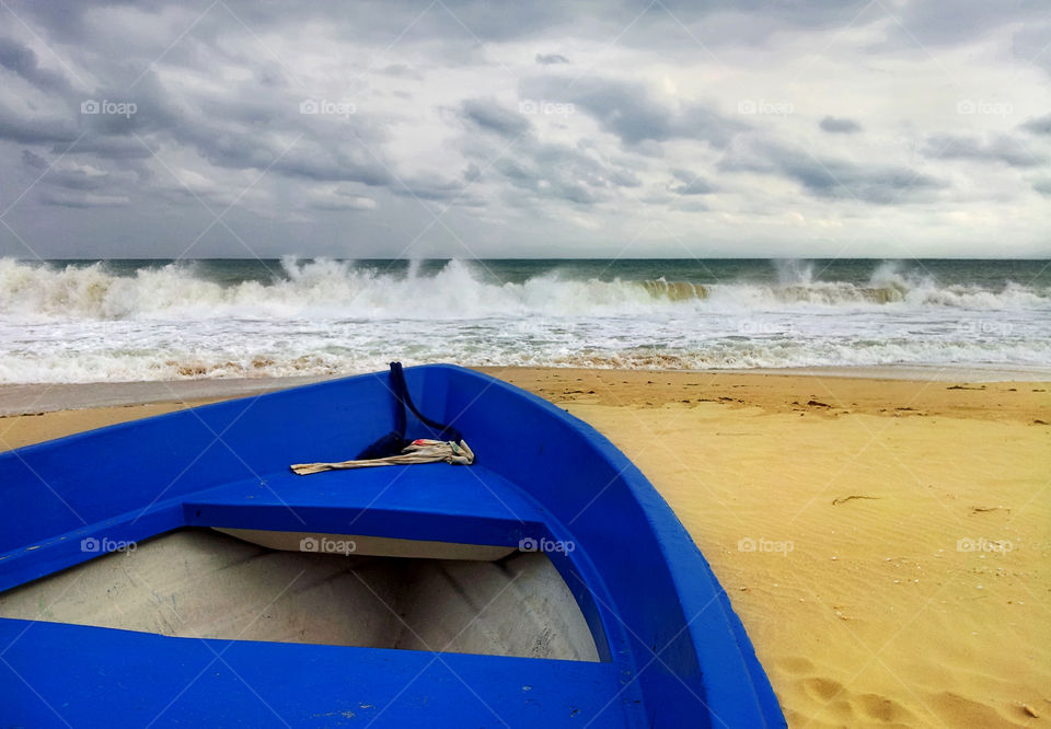 the blue boat on a stormy seaside