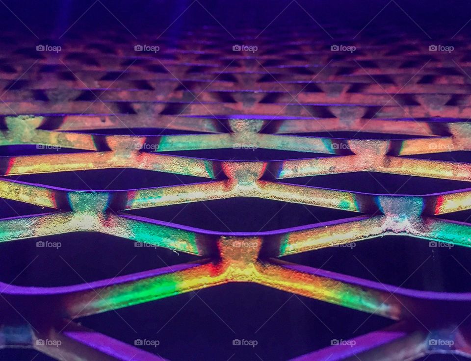 Grill on stage lit with rainbow colors