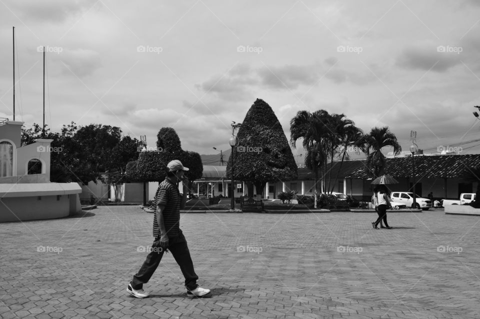 A resident walking in macara's central park in ecuador