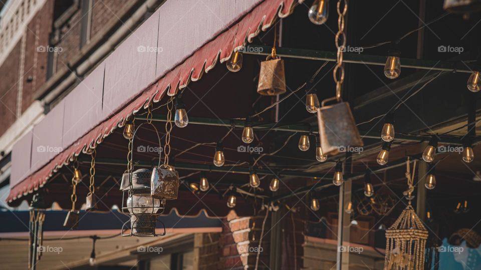 Cowbells and lights in front of shop.