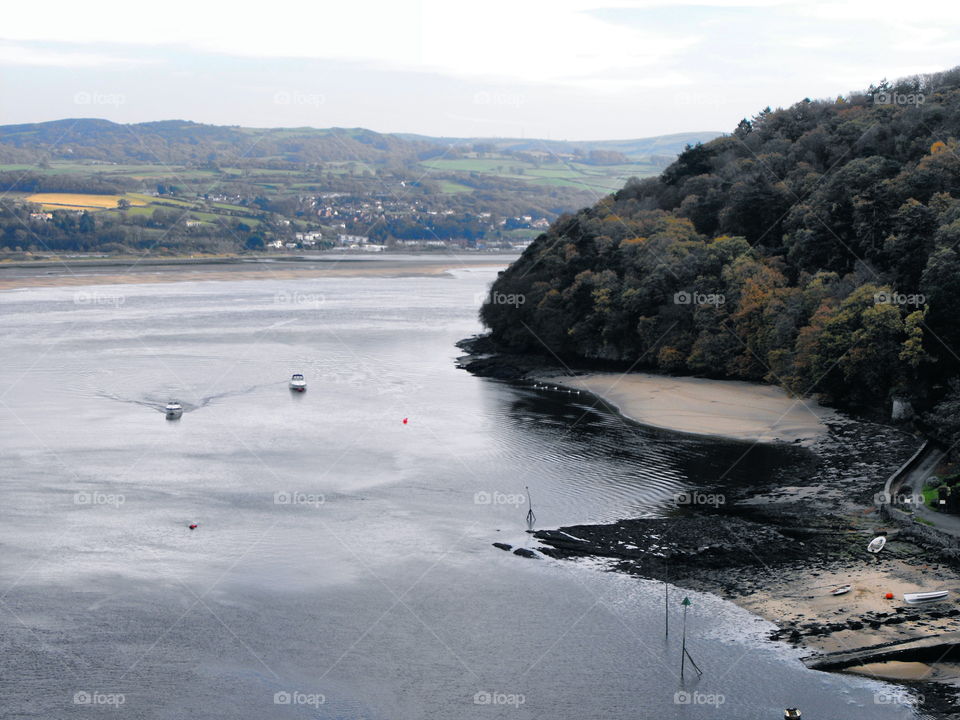 A view in Conwy, North Wales. Woods, boats, sea, distant hills