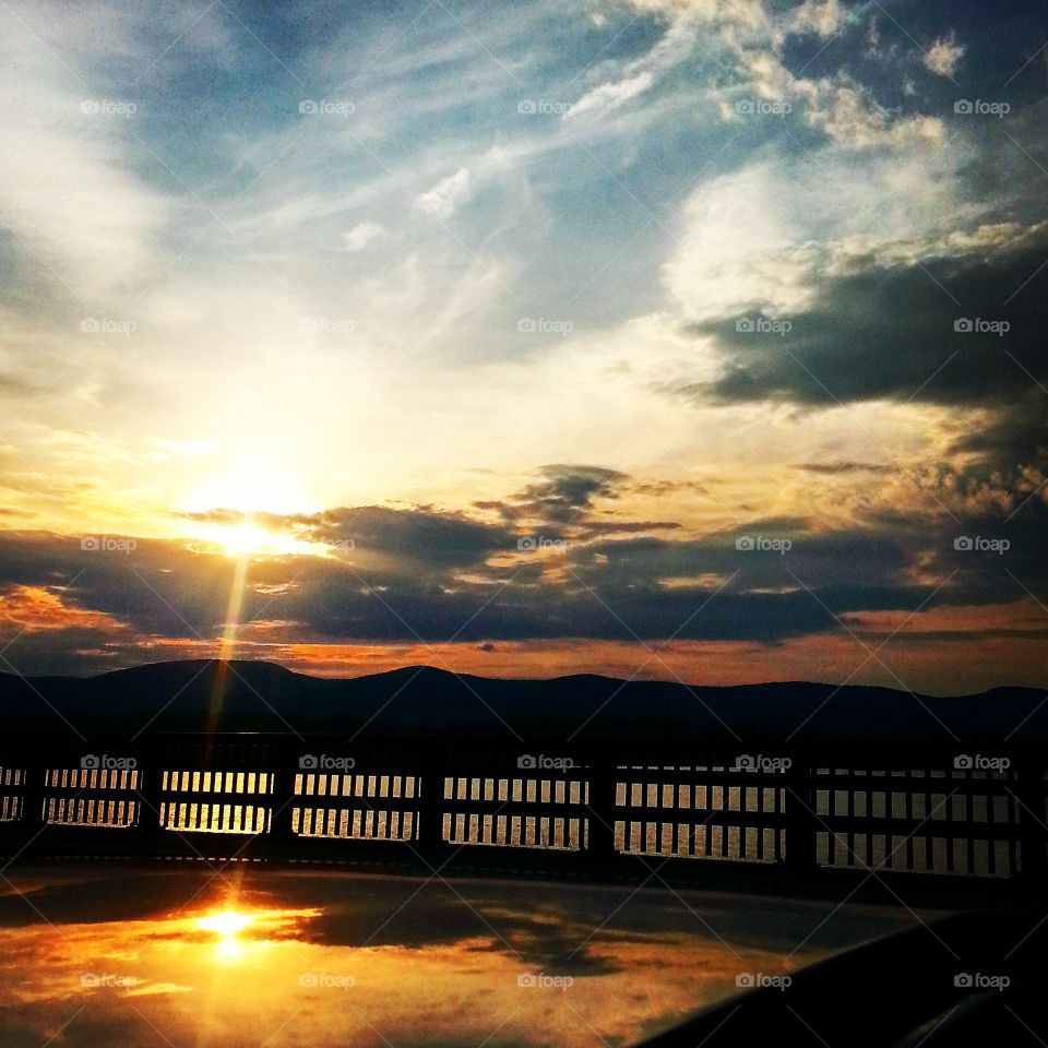 Sunset reflecting off a car and lake